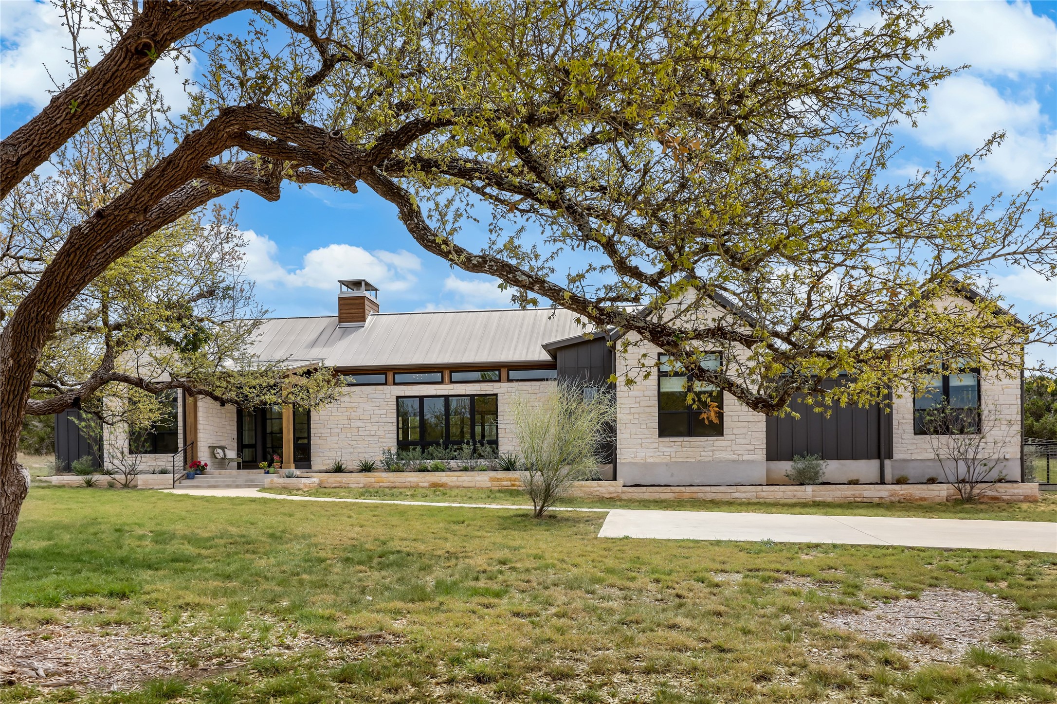329 Calvary Cove Dripping Springs, TX 78620 - Photo 3 of 40 a front view of a house with a yard