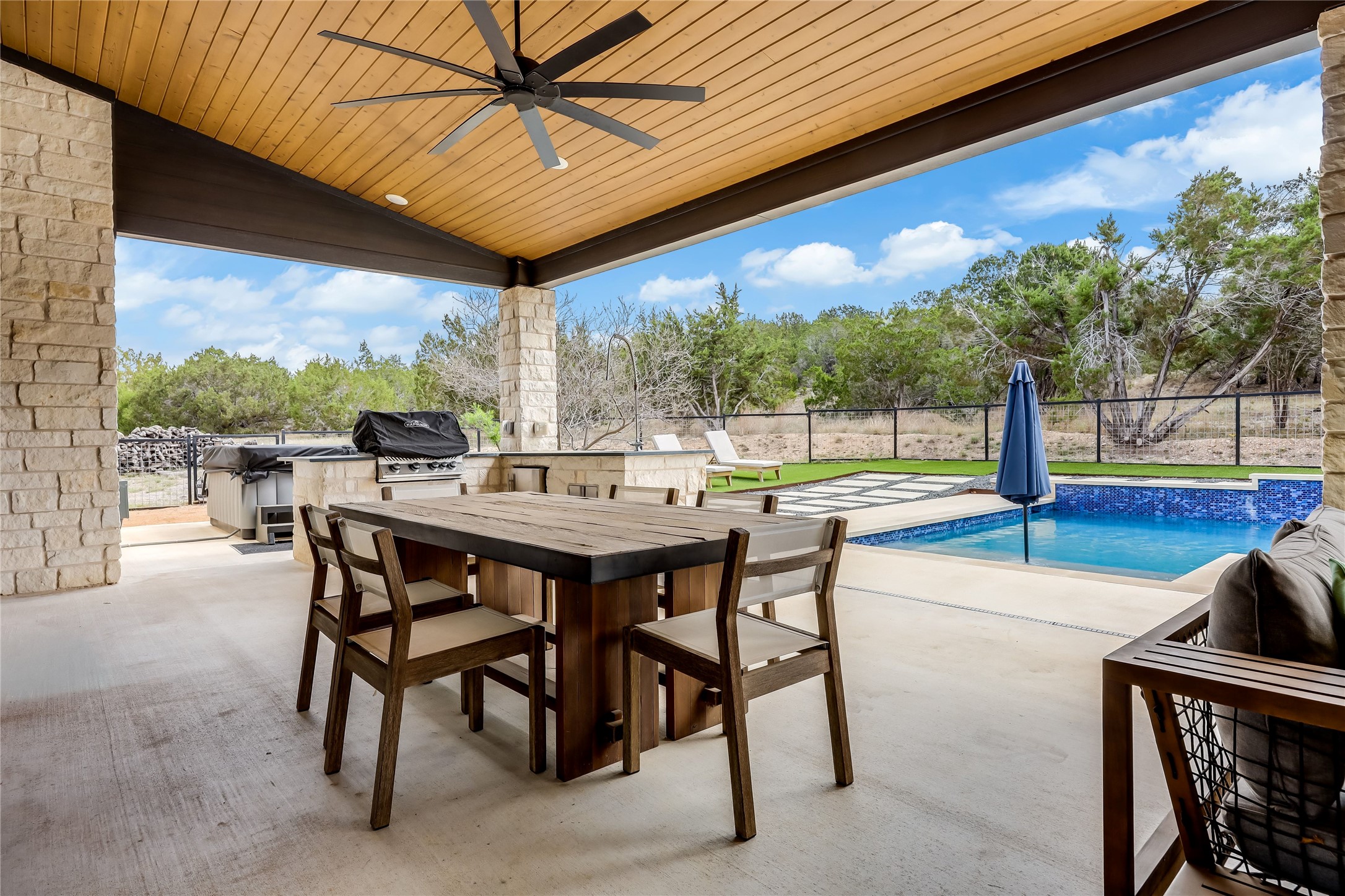 329 Calvary Cove Dripping Springs, TX 78620 - Photo 31 of 40 a view of a patio with a table and chairs