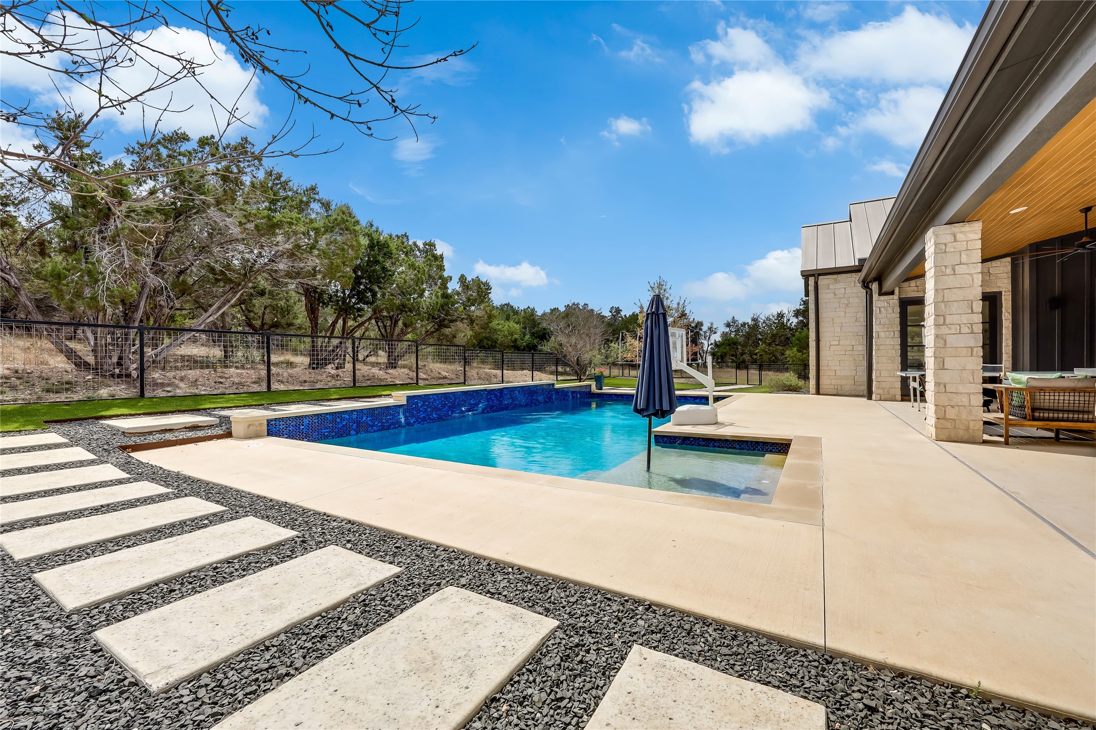 329 Calvary Cove Dripping Springs, TX 78620 - Photo 34 of 40 a view of a swimming pool with an outdoor seating