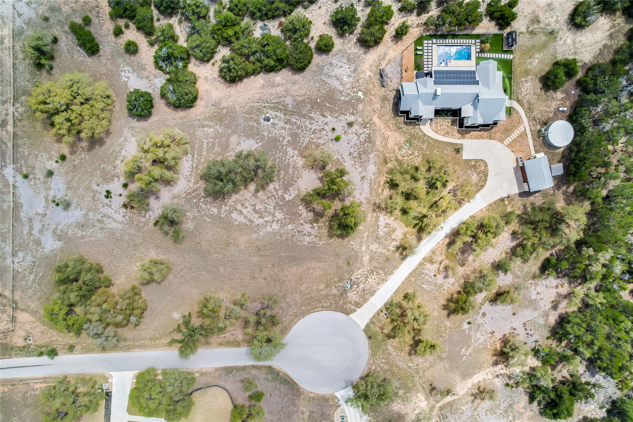 329 Calvary Cove Dripping Springs, TX 78620 - Photo 39 of 40 an aerial view of a house with a yard and a lake view
