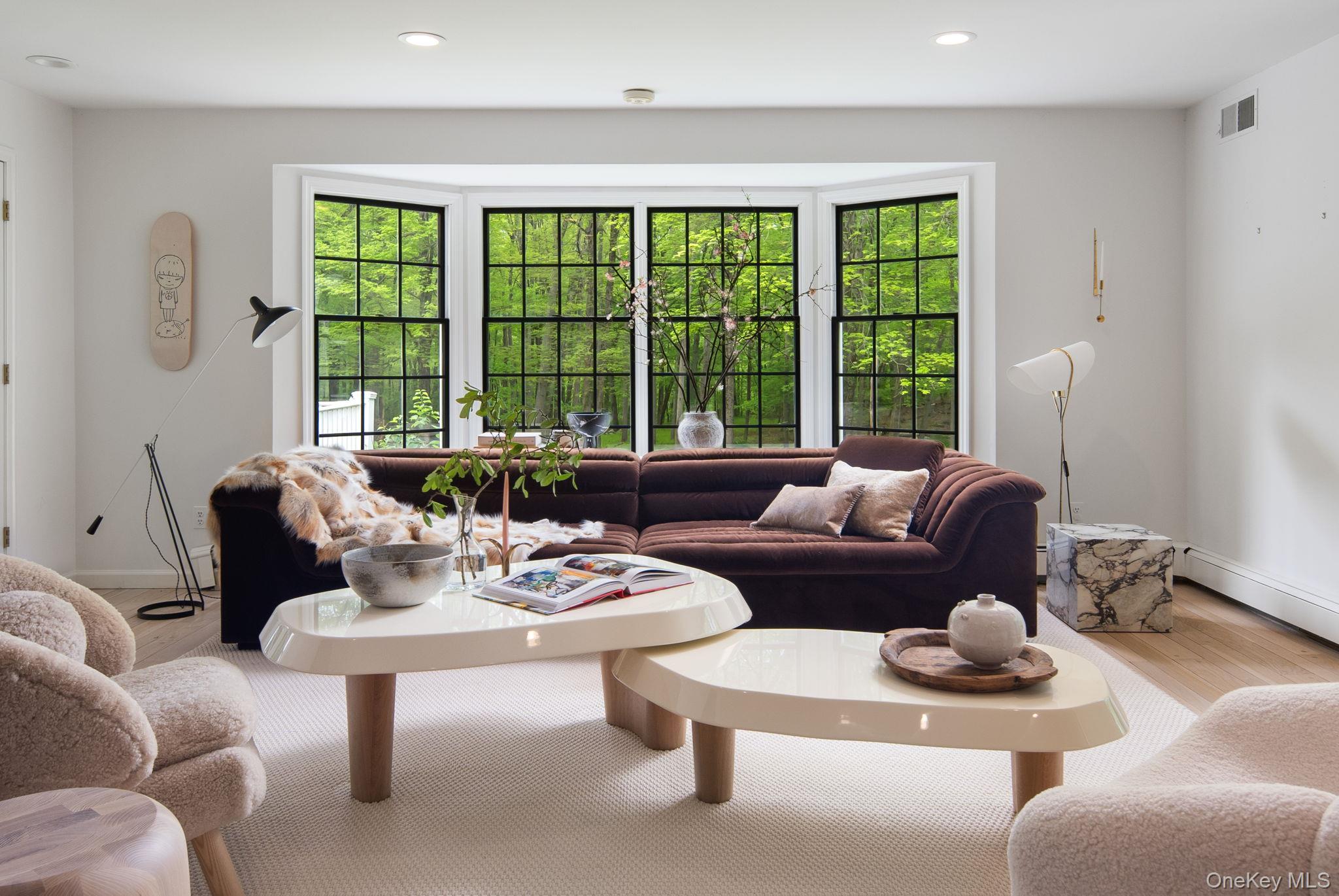 240 Eastwoods Road Pound Ridge, NY 10576 - Photo 25 of 46 a living room with furniture and a large window