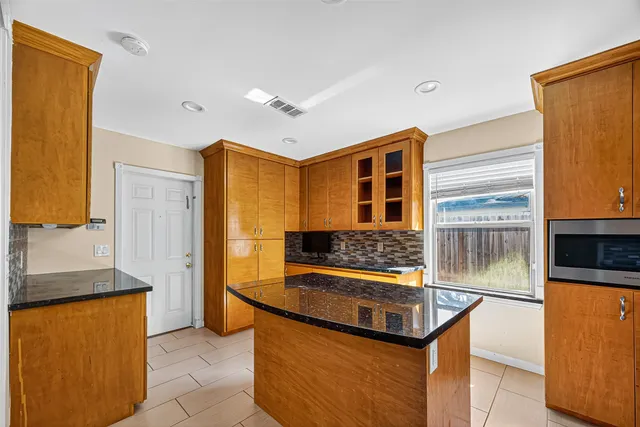 a kitchen with stainless steel appliances granite countertop a stove and a refrigerator