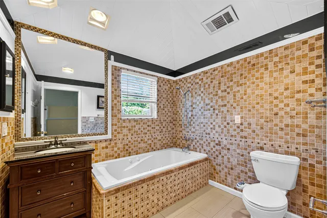 a bathroom with a sink a toilet and shower curtain