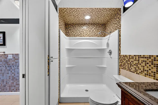 a bathroom with a toilet and a shower