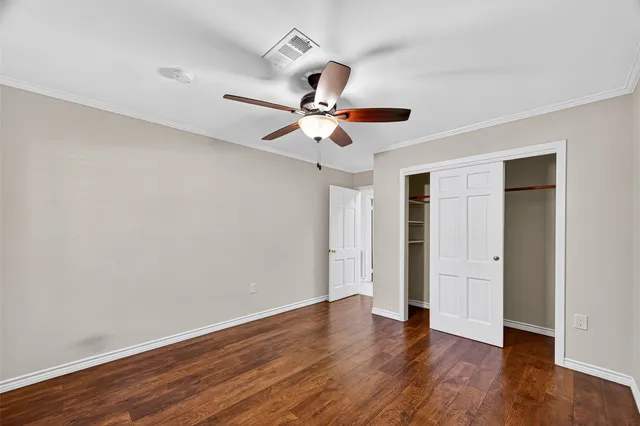 a spacious bathroom with a sink a mirror a toilet and a shower