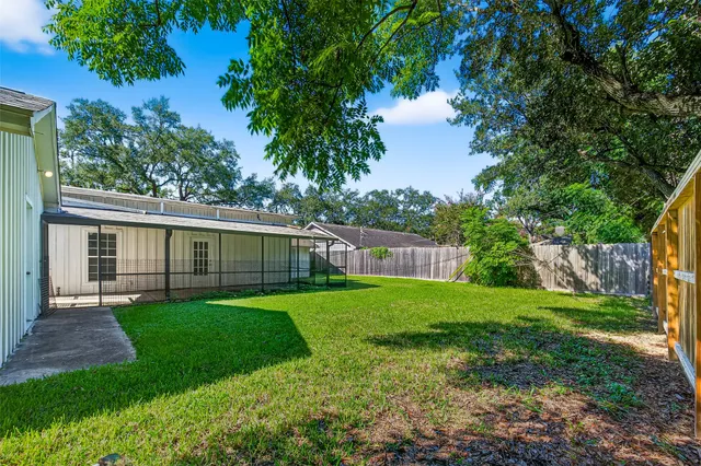 a view of a yard with a house in the background