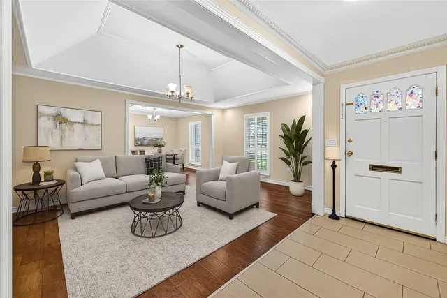a living room with furniture and a chandelier