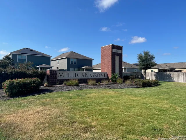 a view of a house with a yard and roof