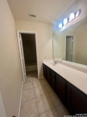 a bathroom with a double vanity sink and mirror
