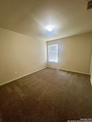 an empty room with a empty space and windows