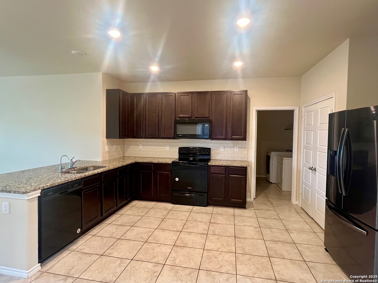 4330 Brigadier Drive Converse, TX 78109 - Photo 6 of 21 a kitchen with a sink a stove top oven and refrigerator