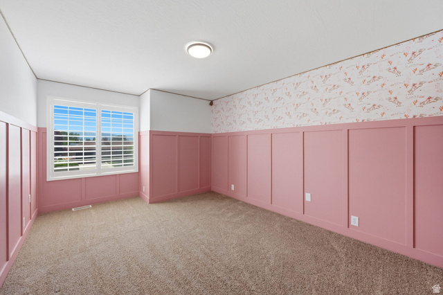 3732 Campbell Road Tooele, UT 84074 - Photo 37 of 69 Interior room featuring pink wainscoting with white trim, complementing a patterned upper wall