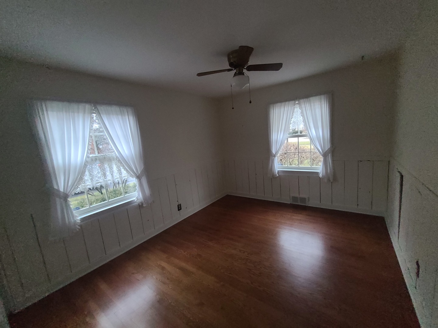 630 Greenview Road Itasca, IL 60143 - Photo 9 of 15 a view of an empty room with wooden floor and a window