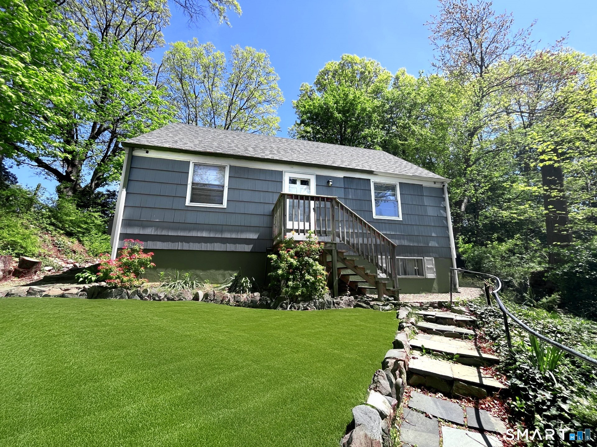 a front view of a house with a garden