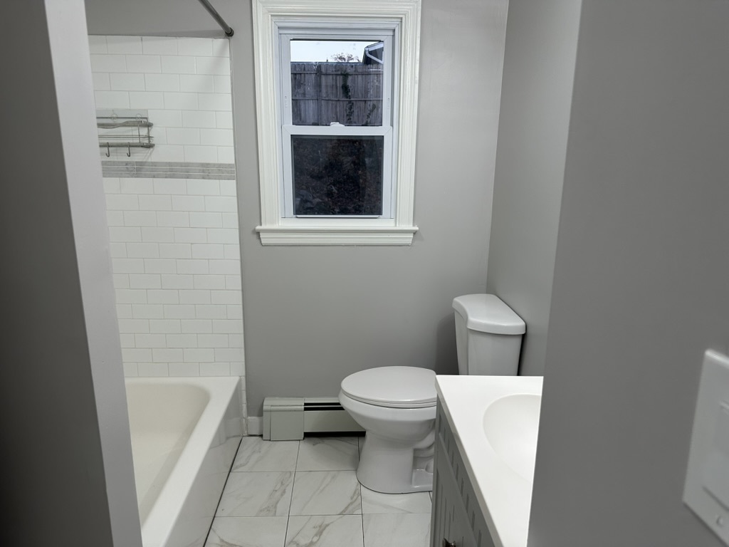 3 Tryon Road Norwalk, CT 06851 - Photo 13 of 25 a white toilet sitting next to a bathroom sink and a tub