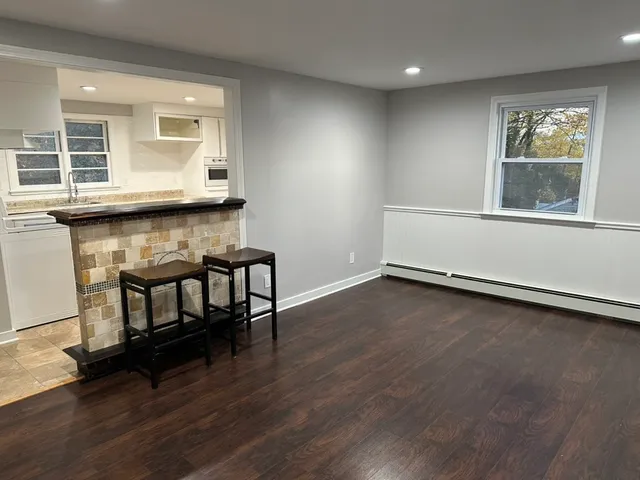 a view of room with window and wooden floor