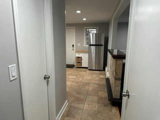 a view of a refrigerator in kitchen and a sink