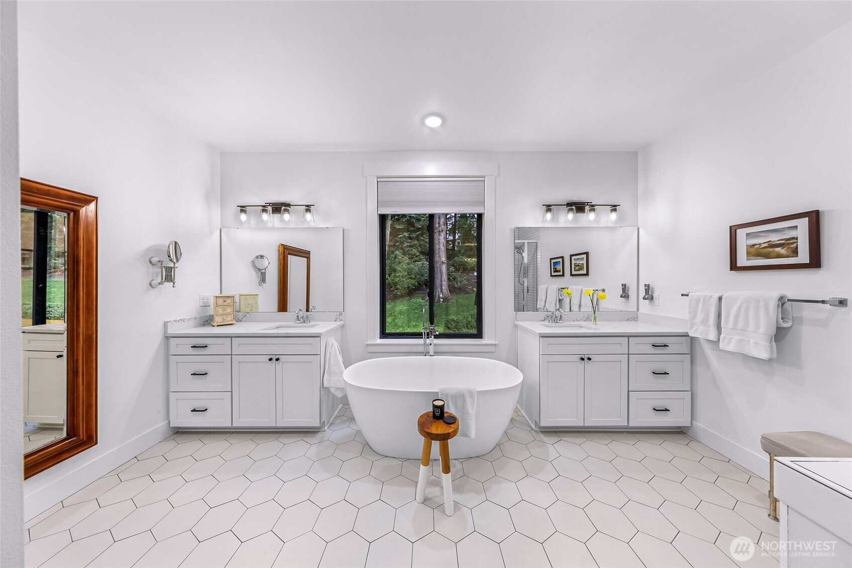 4336 Meander Lane Langley, WA 98260 - Photo 20 of 36 a spacious bathroom with a double vanity sink a mirror a bathtub and a window