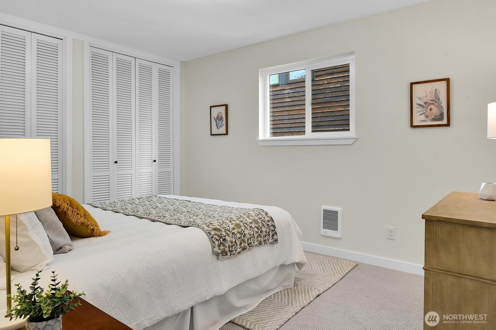 161 Valley Street Seattle, WA 98109 - Photo 11 of 40 a bedroom with a bed and wooden floor