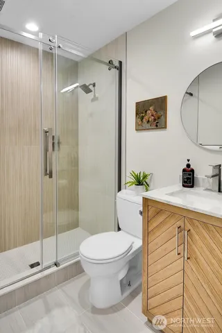 a bathroom with a toilet a sink and shower