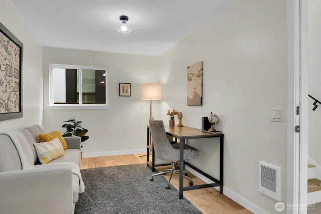 a view of a livingroom with workspace and a couch