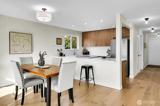 a view of a dining room with furniture and a chandelier