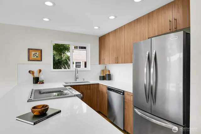 a kitchen with sink a refrigerator and a stove