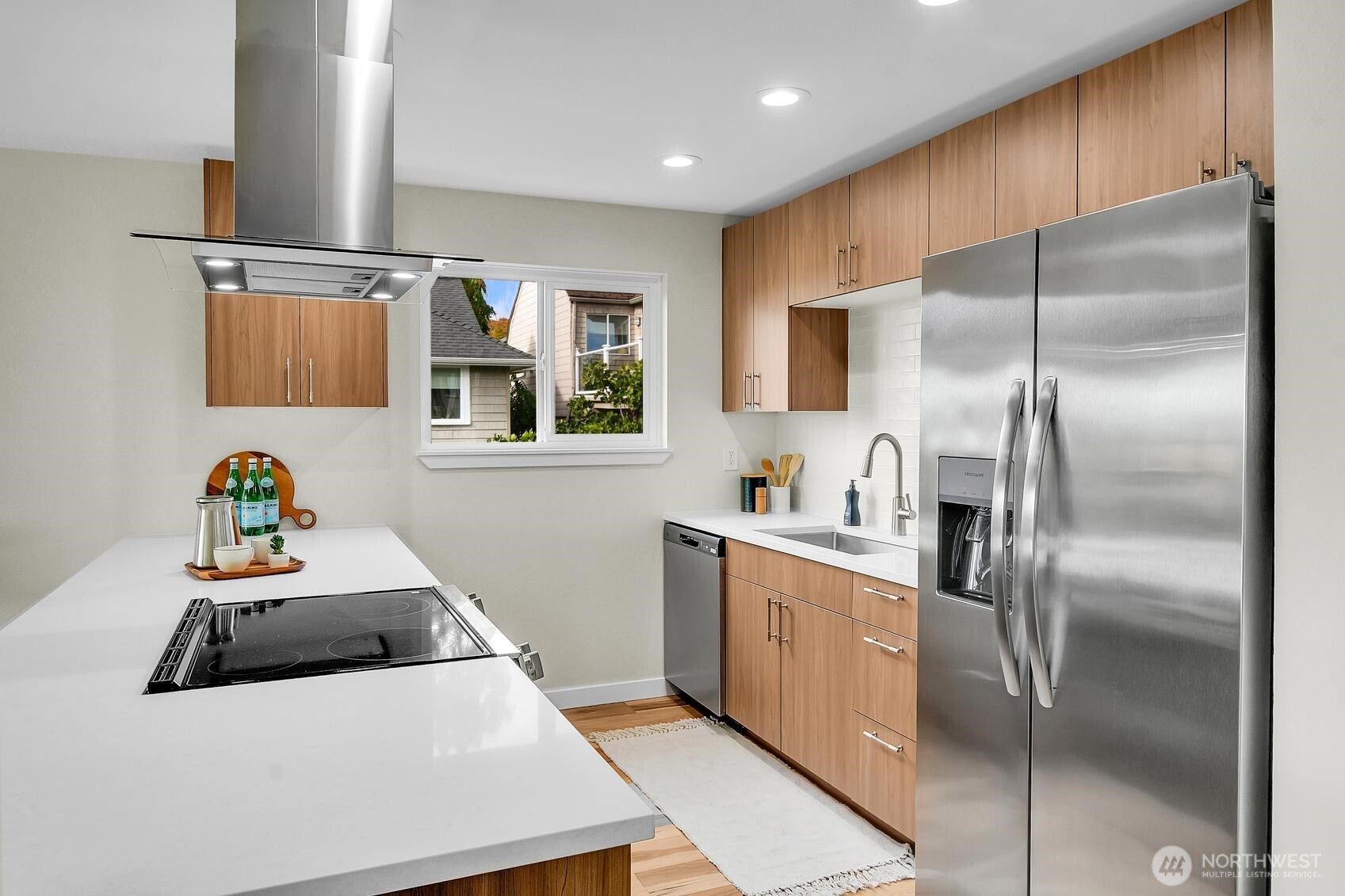161 Valley Street Seattle, WA 98109 - Photo 3 of 40 a kitchen with stainless steel appliances a refrigerator sink and white cabinets