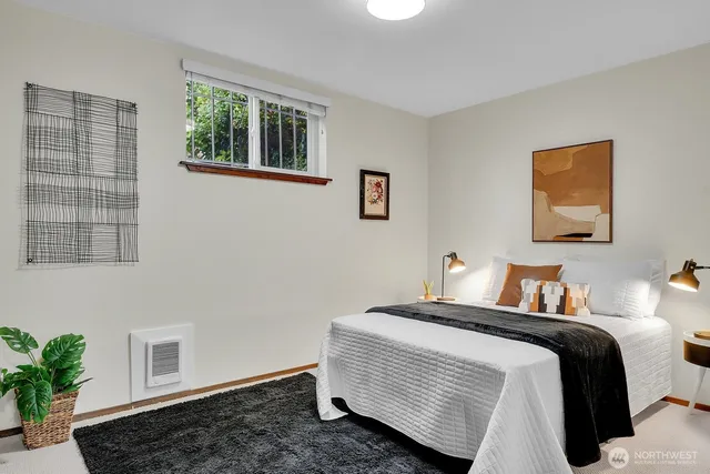 a bedroom with a bed and a painting on the wall