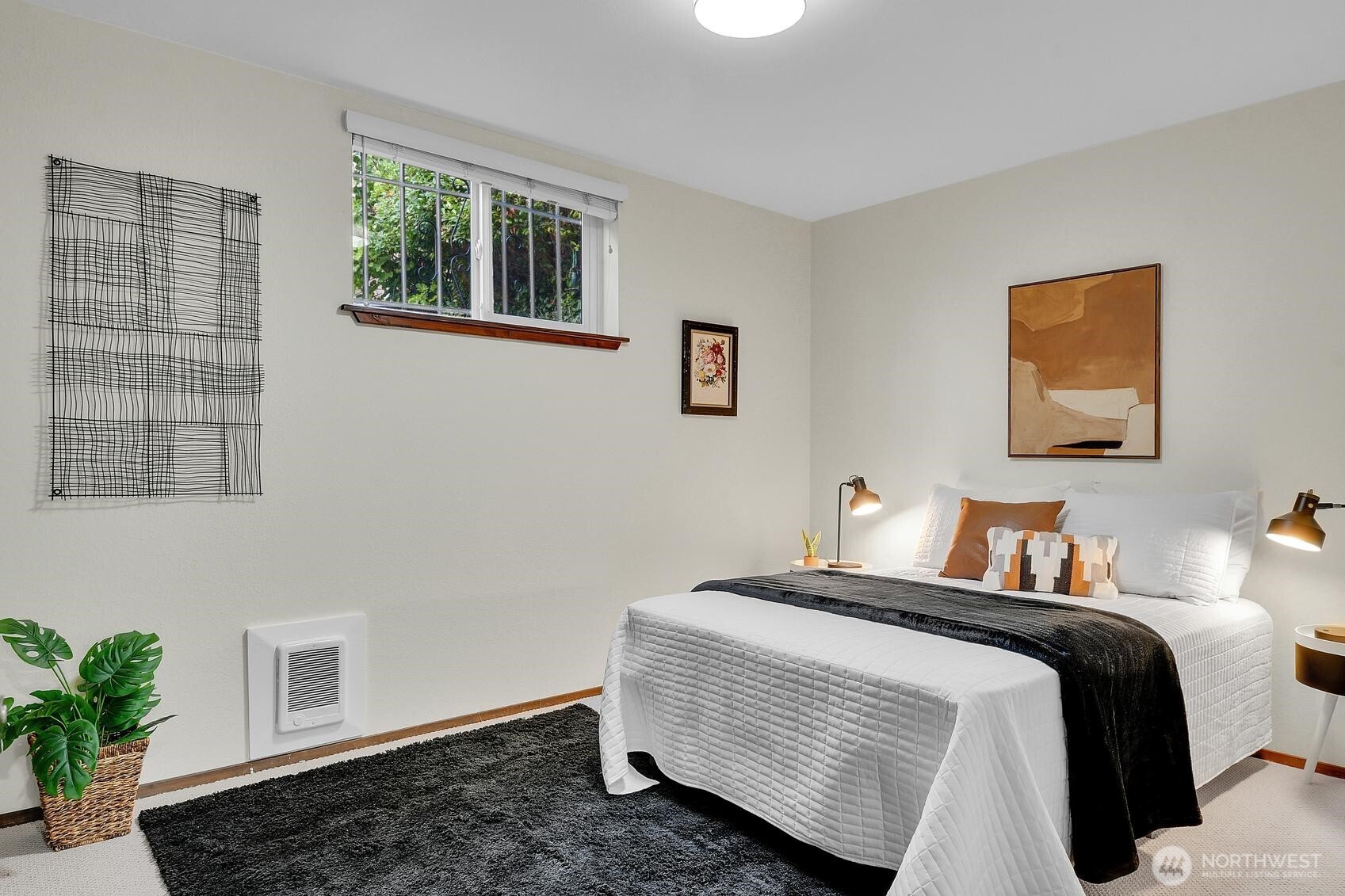 161 Valley Street Seattle, WA 98109 - Photo 33 of 40 a bedroom with a bed and a painting on the wall