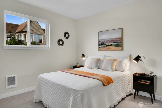 a bedroom with a bed and a painting on the wall