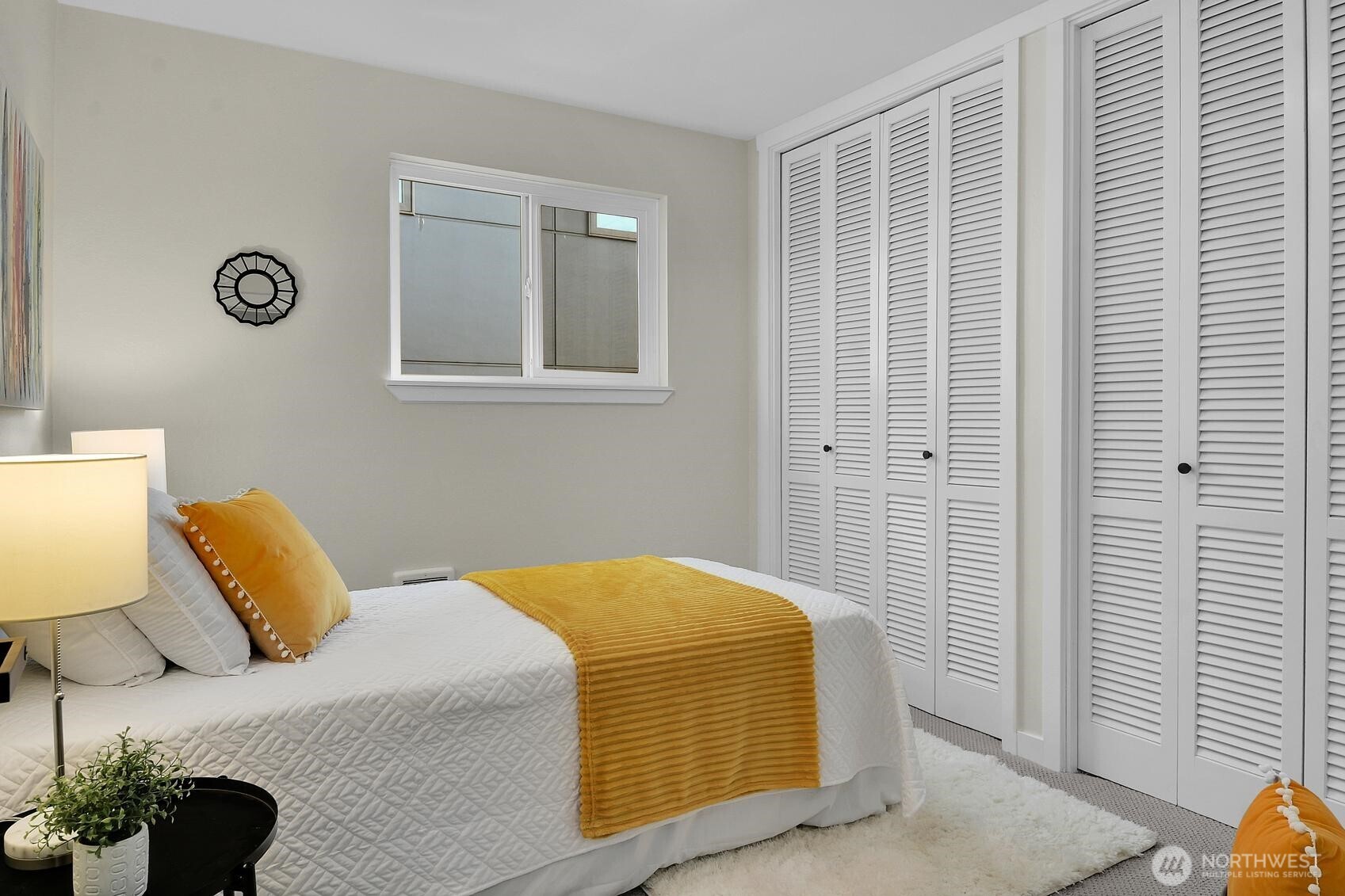 161 Valley Street Seattle, WA 98109 - Photo 10 of 40 a bedroom with a bed and a potted plant