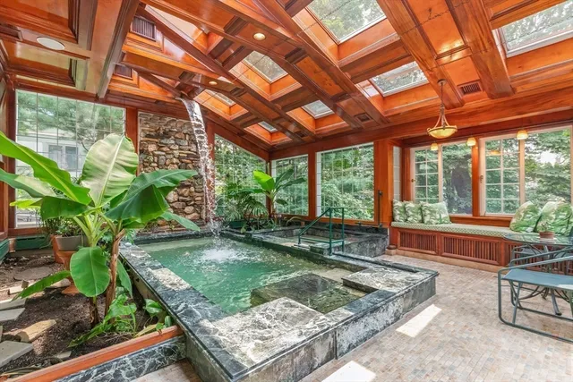 a view of a backyard with a tub and wooden fence
