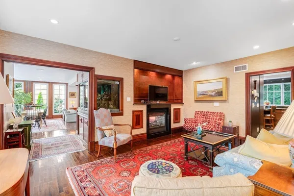 a living room with furniture a flat screen tv and a fireplace