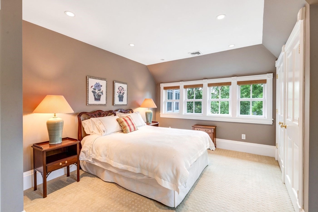 45 Parley Avenue Boston, MA 02130 - Photo 17 of 26 a bedroom with a large bed and a lamp on table