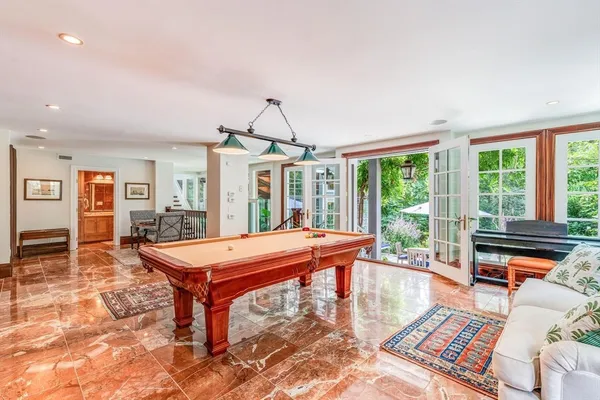 a room with pool table and windows