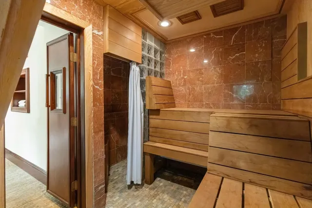 a front view of a house with a yard and potted plants