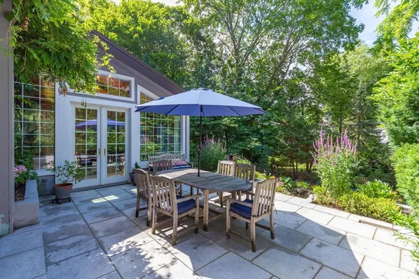 a view of a patio with a table and chairs under an umbrella