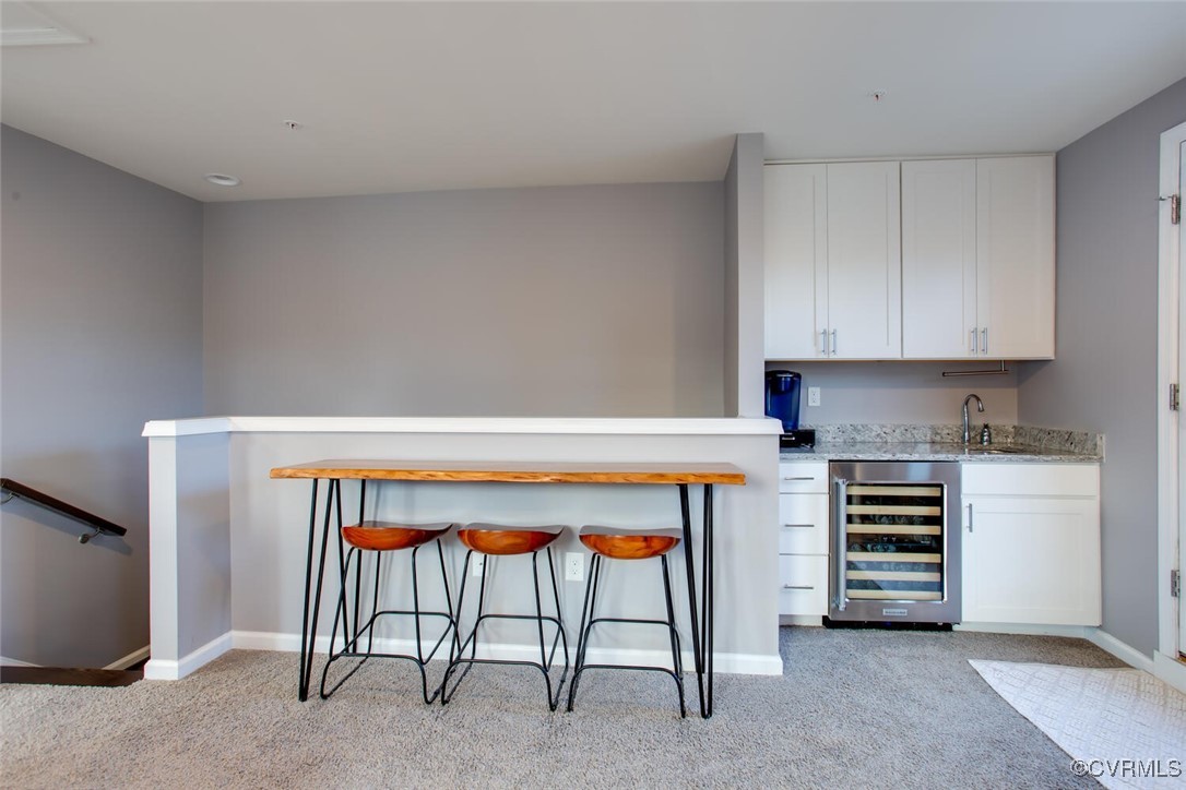 447 Nottoway Walk Alexandria, VA 22304 - Photo 25 of 49 Indoor wet bar with wine cooler and light carpet