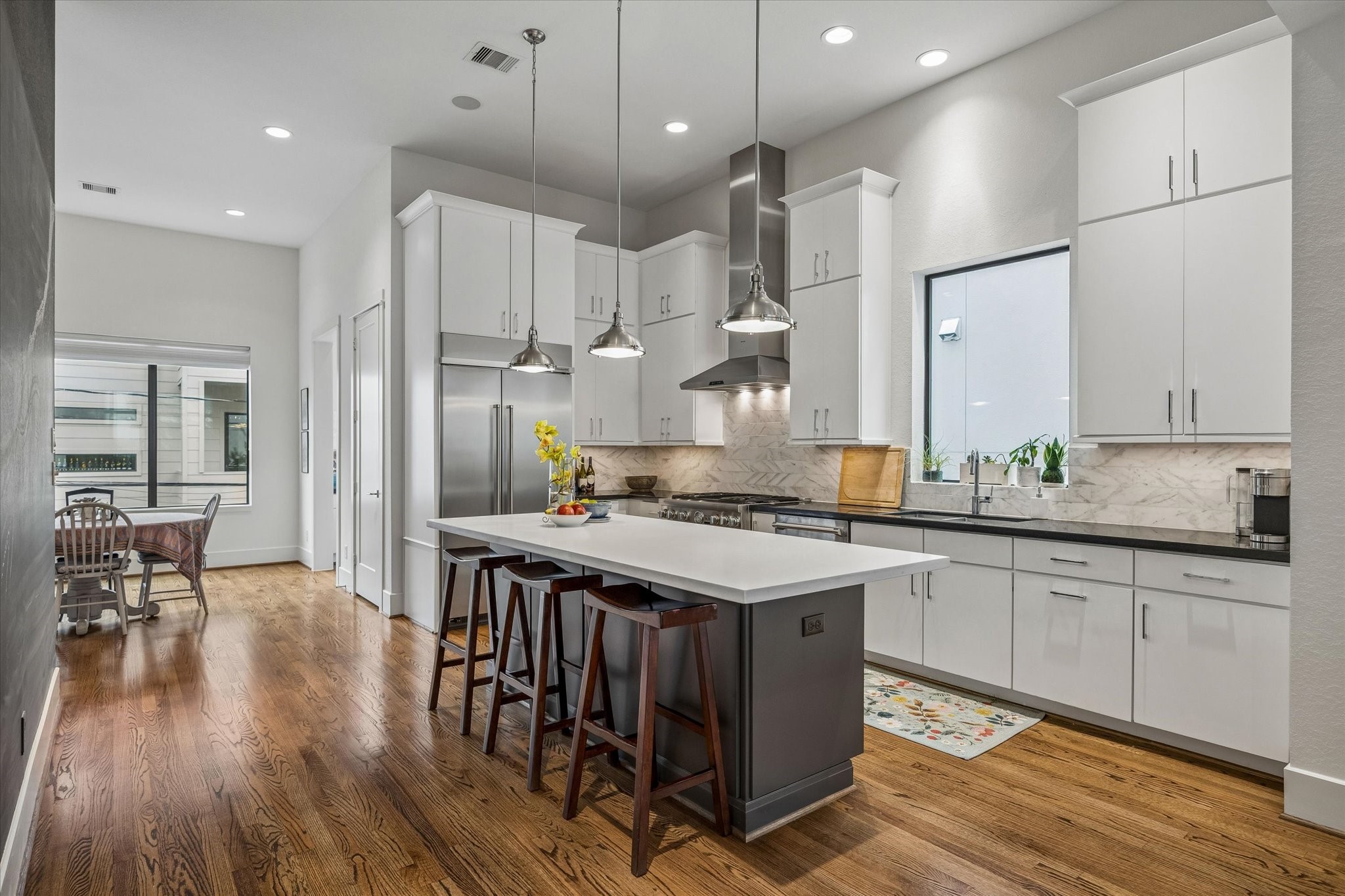 1526 Vermont Street Houston, TX 77006 - Photo 22 of 39 Another view of the kitchen showcasing abundant cabinetry, expansive prep space, and a clean, sophisticated design.