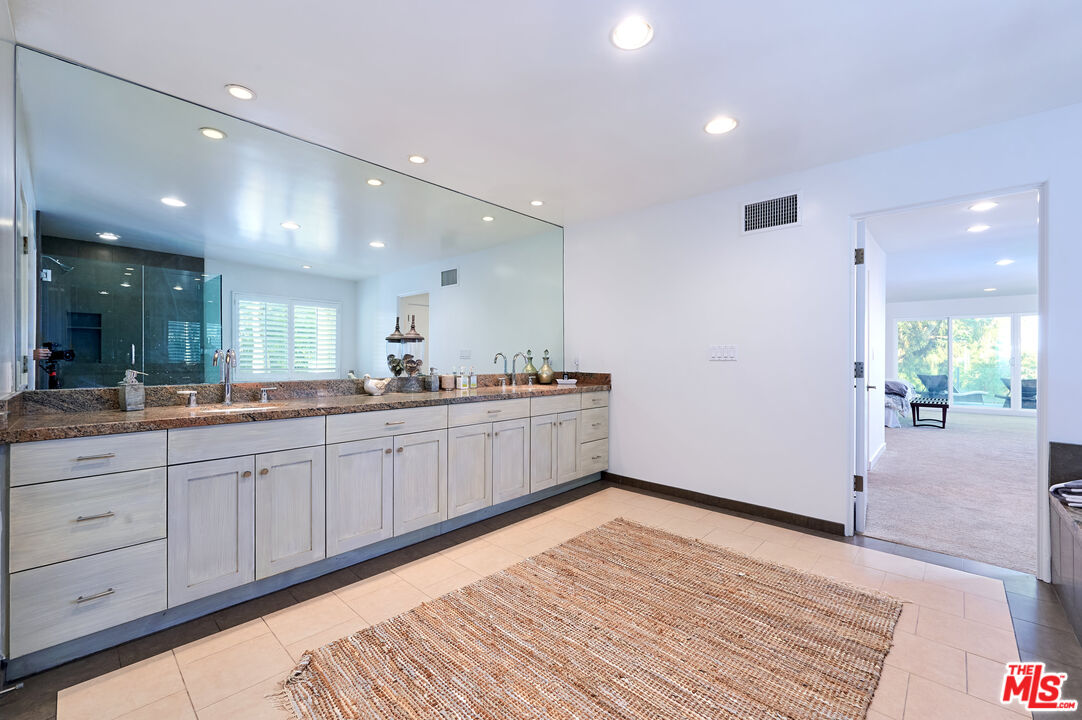 28907 Wight Road Malibu, CA 90265 - Photo 36 of 54 a large kitchen with stainless steel appliances a large counter top a stove and a refrigerator