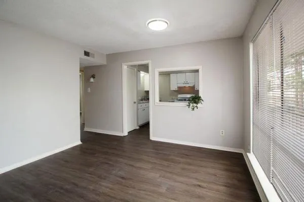 wooden floor in an empty room with a window