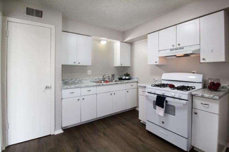 592 Patterson Street Memphis, TN 38111 - Photo 15 of 19 a kitchen with granite countertop white cabinets and white appliances