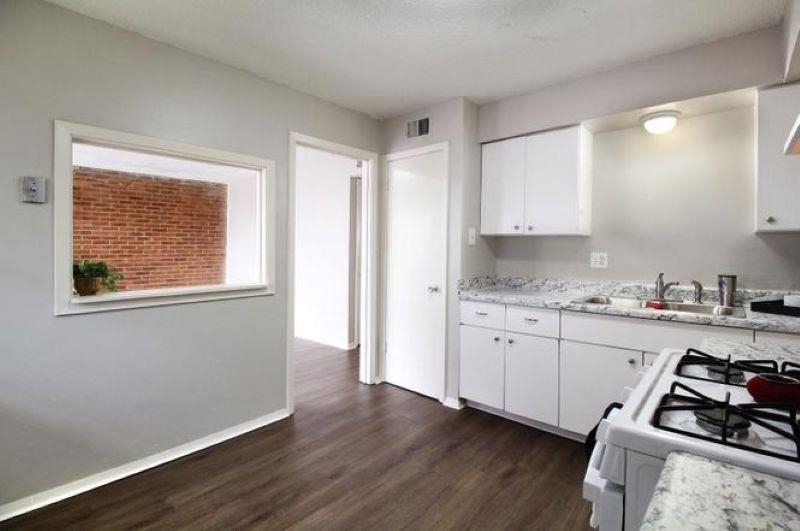 592 Patterson Street Memphis, TN 38111 - Photo 16 of 19 a kitchen with granite countertop a stove a sink and a refrigerator