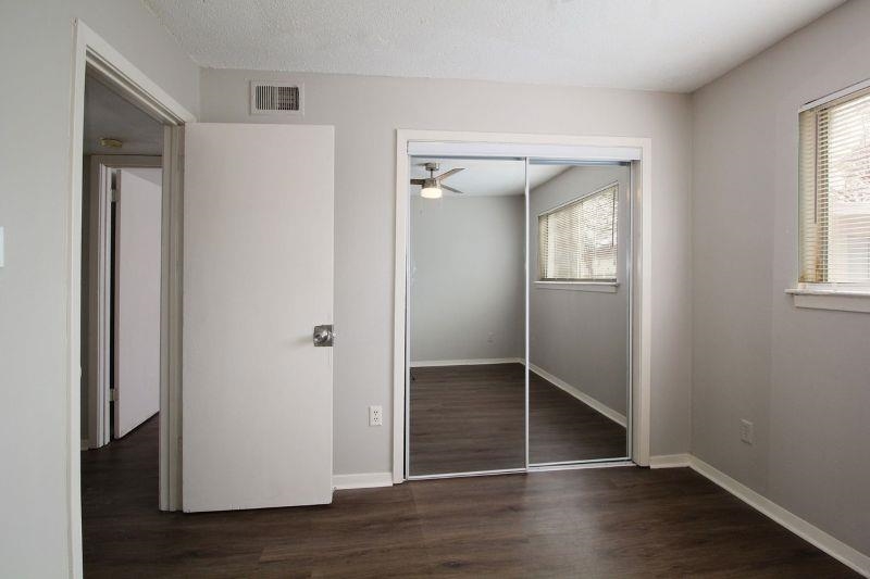 592 Patterson Street Memphis, TN 38111 - Photo 18 of 19 an empty room with wooden floor closet and windows