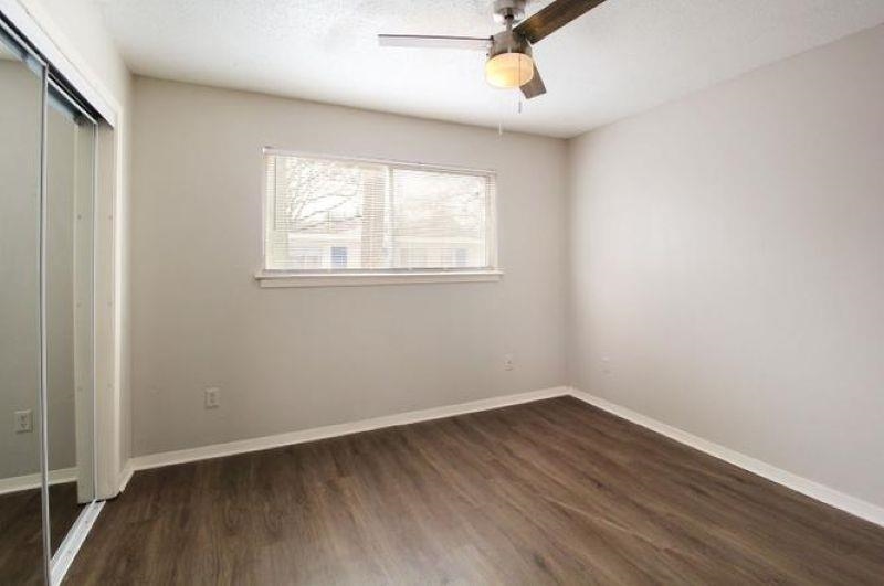 592 Patterson Street Memphis, TN 38111 - Photo 4 of 19 an empty room with wooden floor and windows