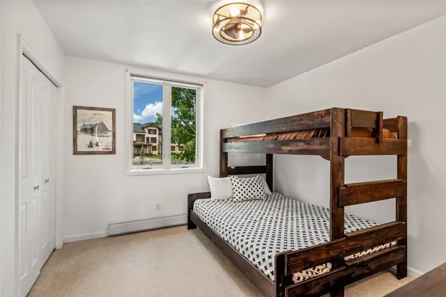 a bathroom with a granite countertop sink toilet a shower and a mirror