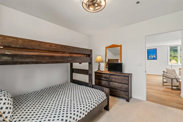 a view of a hallway with closet and wooden floor