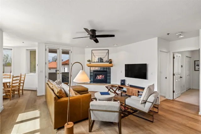 a living room with furniture a fireplace and a flat screen tv