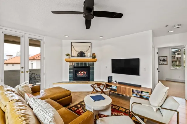 a living room with furniture a fireplace and a flat screen tv